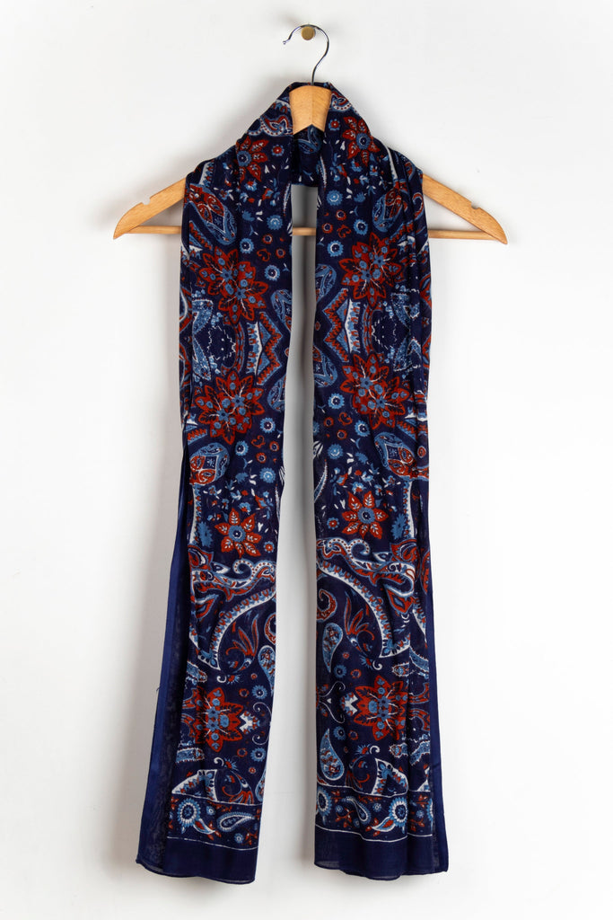 showing the scarf draped around a coat hanger, showing the all over pattern and how it would look when worn