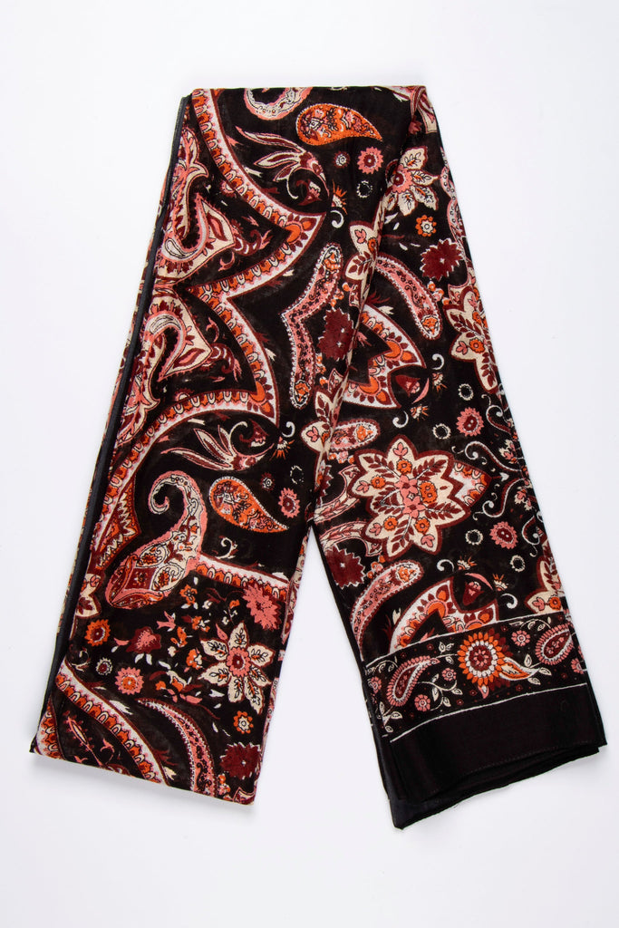 black scarf with a vibrant orange mosaic style paisley floral print pattern all over, the scarf has a plain black bordered edge