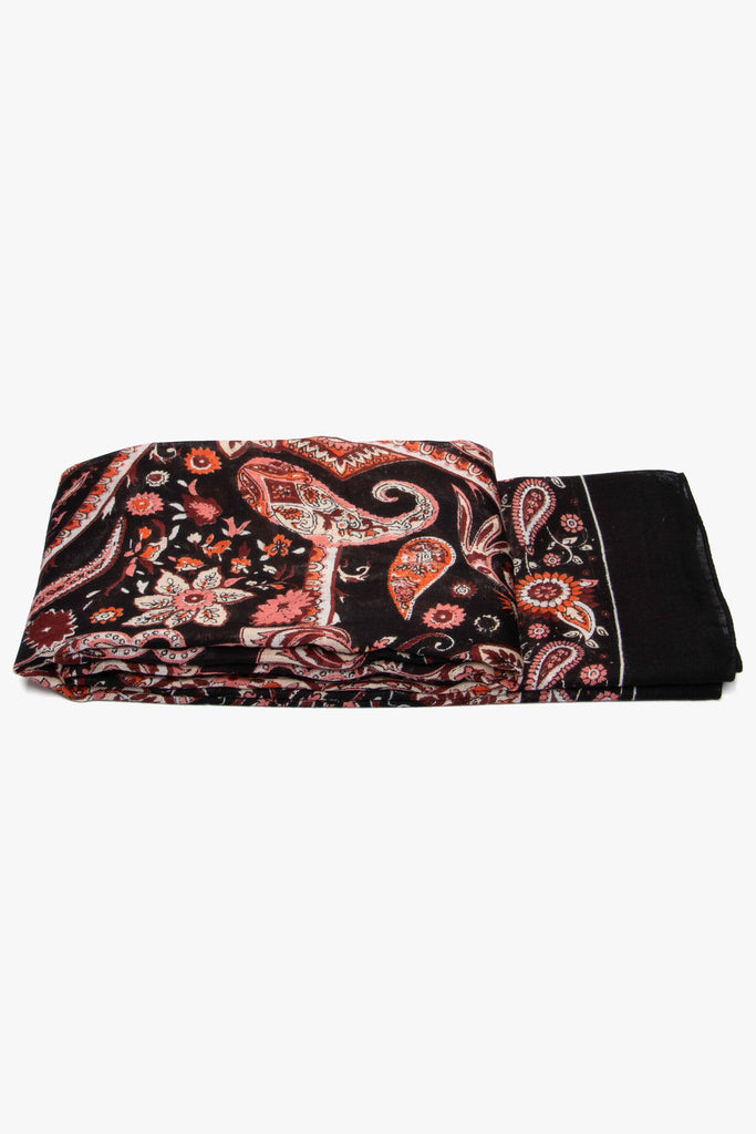 showing the scarf draped around a coat hanger, showing the all over pattern and how it would look when worn