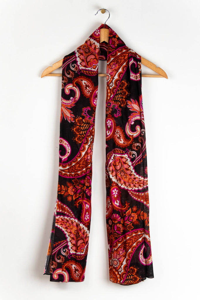 showing the scarf draped around a coat hanger, showing the all over pattern and how it would look when worn