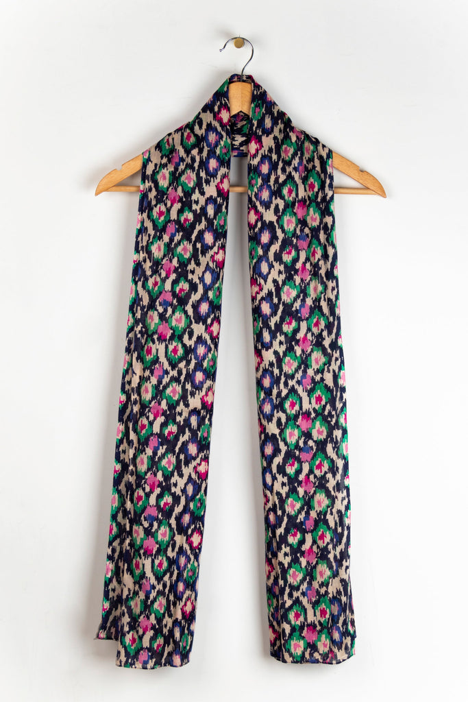 showing the scarf draped around a coat hanger, showing the all over pattern and how it would look when worn