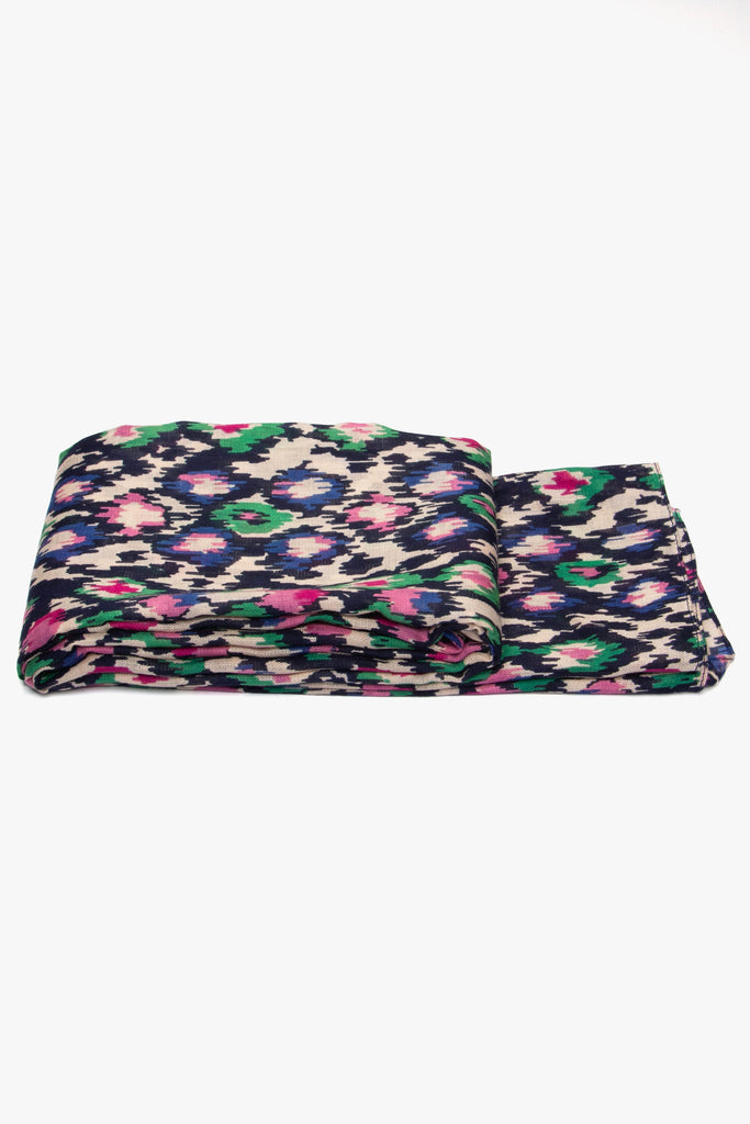 side view of the scarf when folded, showing the texture and thickness of the material. this scarf is lightweight