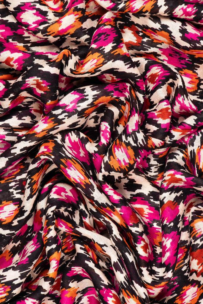 close up of the soft viscose fabric, the pink, black and orange colourways are clearly visible