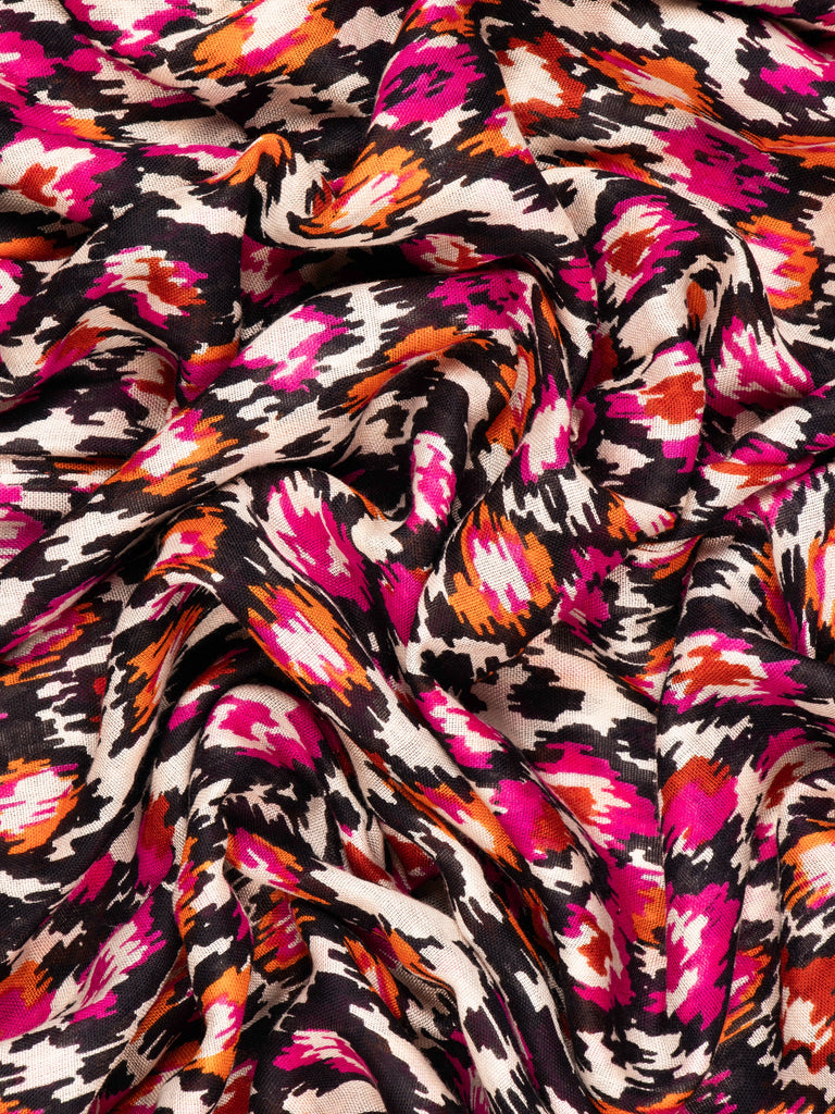 close up of the soft viscose fabric, the pink, black and orange colourways are clearly visible