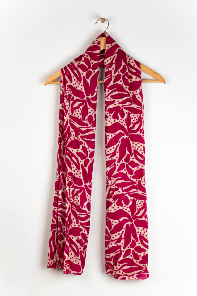 showing the scarf draped around a coat hanger, showing the all over pattern and how it would look when worn