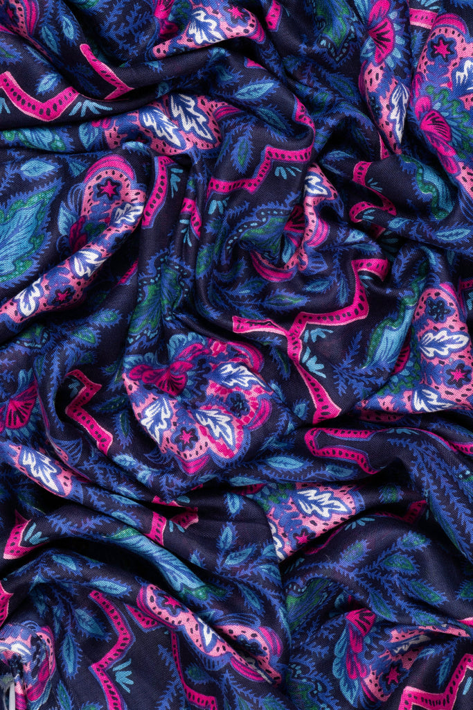 showing the scarf folded, the blue and pink floral mosaic pattern is clearly shown and covers the entire scarf.