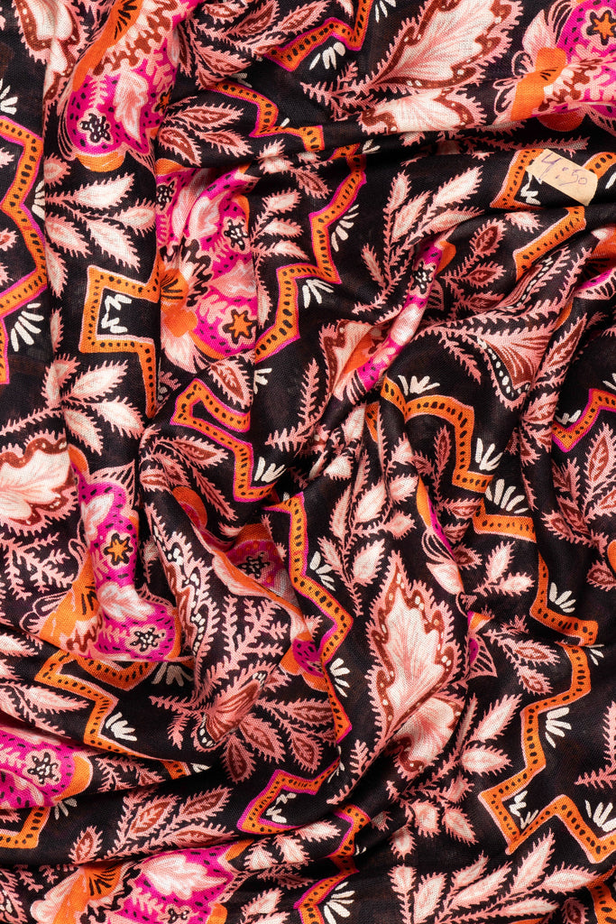close up of the soft viscose fabric, the black, pink and coral colourways are clearly visible