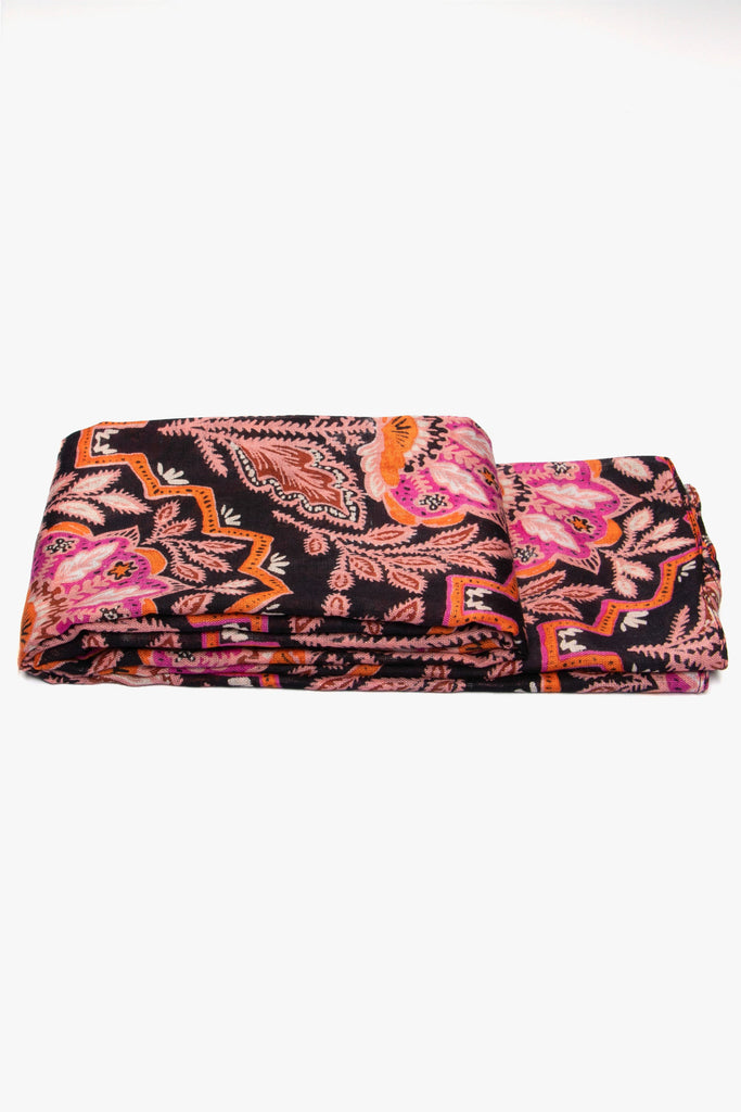 side view of the scarf when folded, showing the texture and thickness of the material. this scarf is lightweight