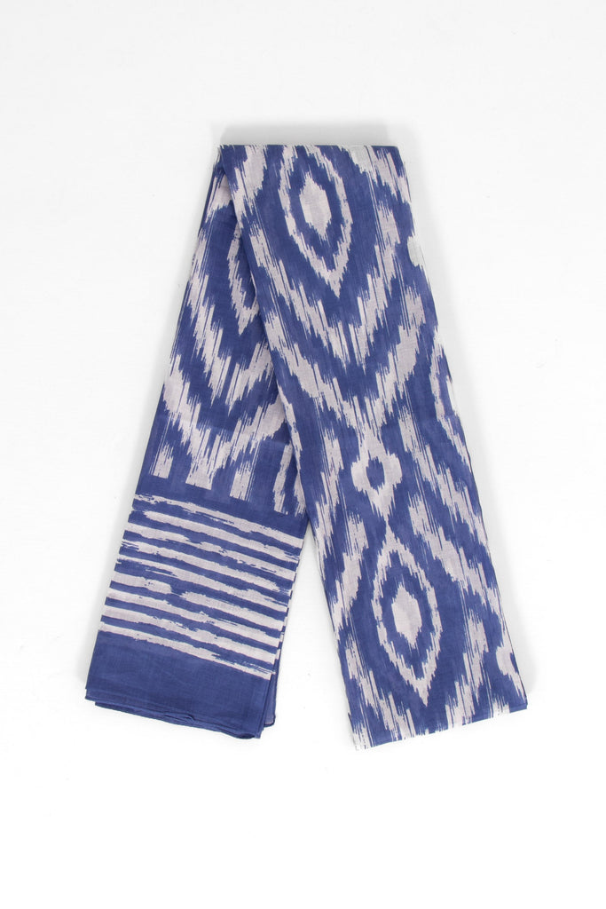showing the scarf folded, the colourful blue aztec pattern is shown to cover the design. the scarf also has a bordered edge which is partially striped.
