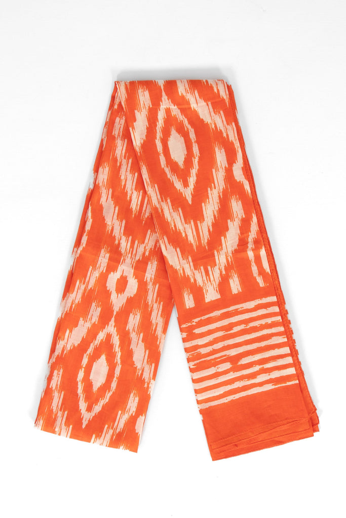showing the scarf folded, the colourful orange aztec pattern is shown to cover the design. the scarf also has a bordered edge which is partially striped.