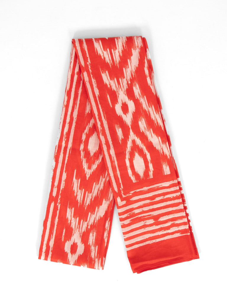 showing the scarf folded, the colourful red aztec pattern is shown to cover the design. the scarf also has a bordered edge which is partially striped.