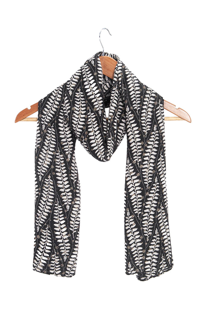 clover-black-fern-leaf-lightweight-scarf-draped-on-coat-hanger