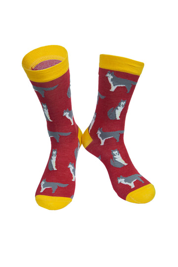 red socks with a yellow heel, toe and cuff with an all over pattern of husky dogs