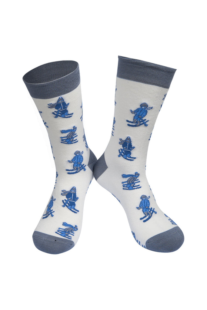 white socks with grey, heel, toe and cuff with a pattern of blue skiers all over