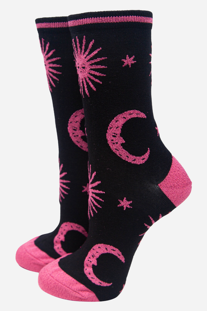 black socks with pink stars, crescent moons and suns with pink sparkly glitter accents 