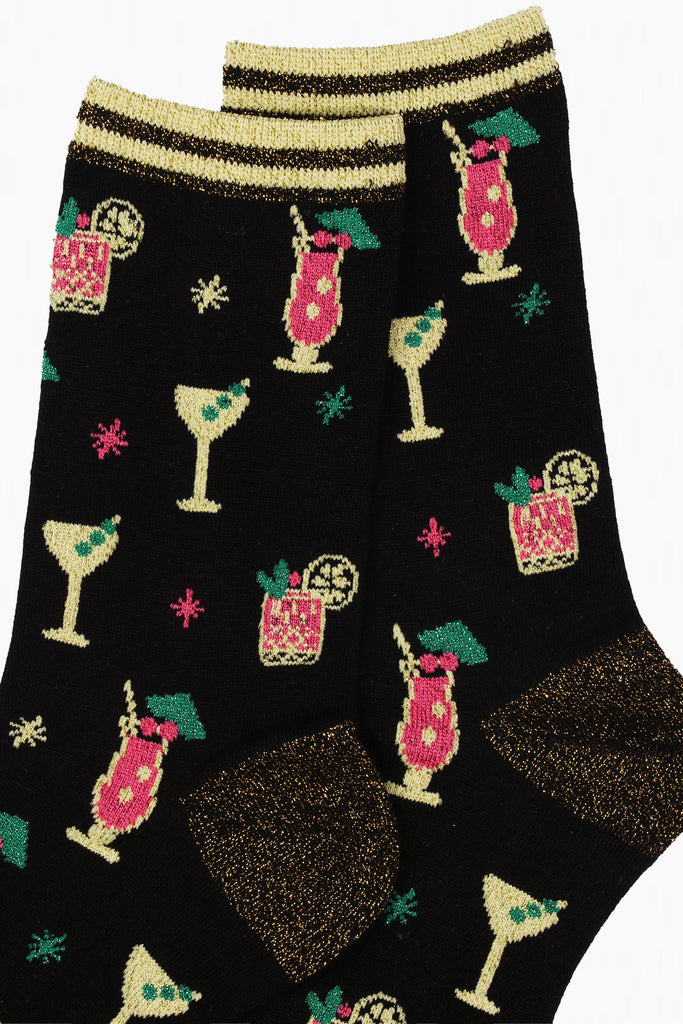 close up of the cocktail glasses and gold sparkly accents on the bamboo socks