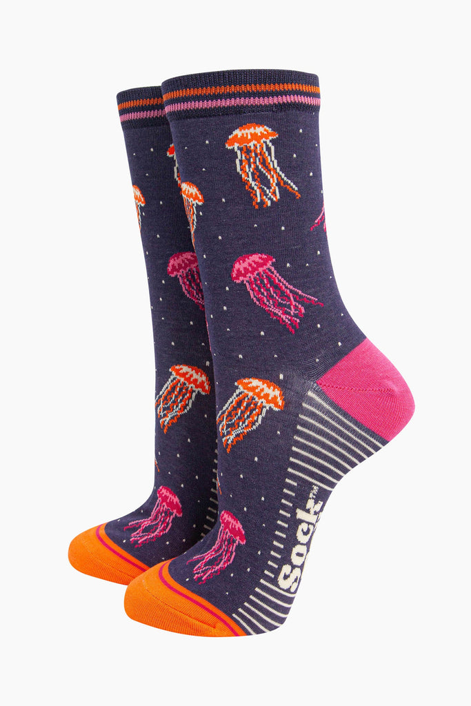 womens-bamboo-socks-navy-jellyfish-showing-the-pattern-of-pink-and-orange-floating-jellyfish-covering-the-design