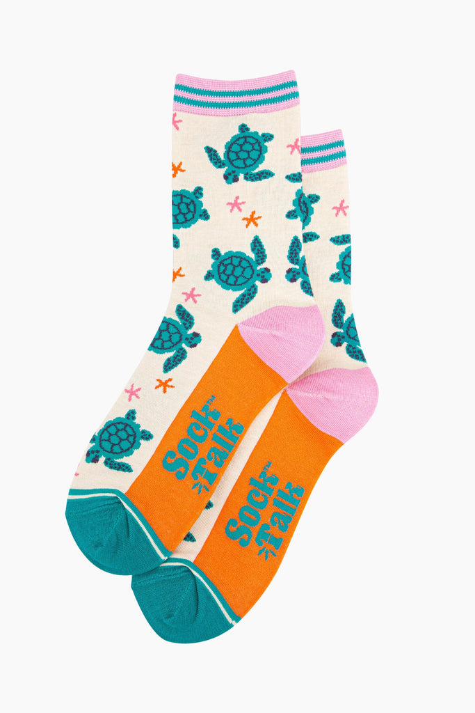 womens-bamboo-socks-cream-sea-turtles-and-starfish-laying-flat-the-pattern-covers-the-body-of-the-design