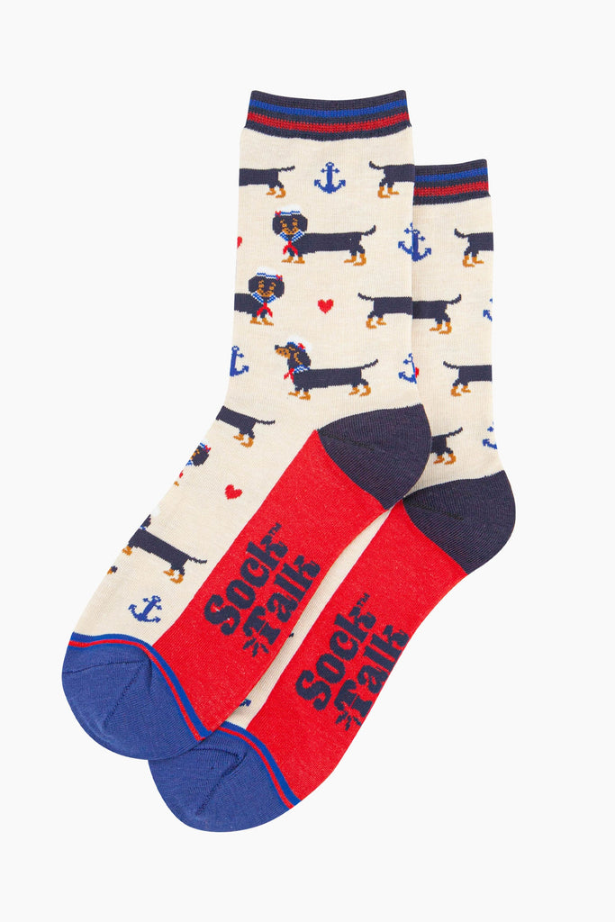 womens-bamboo-socks-cream-sausage-dog-sailor-laying-flat-the-pattern-covers-the-full-design