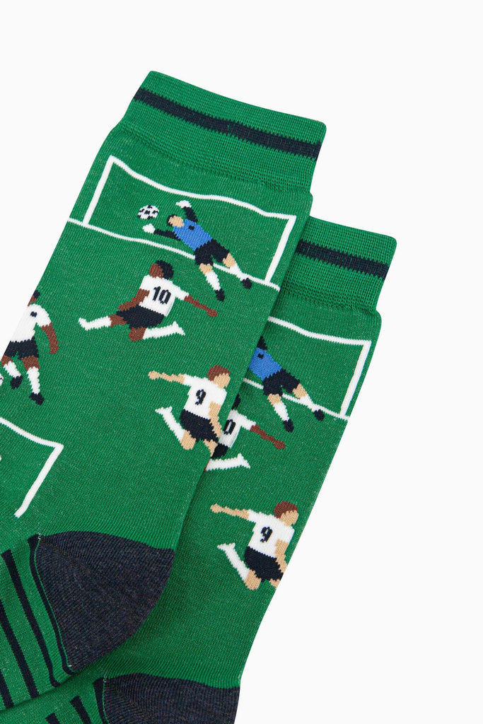 mens-bamboo-socks-green-football-players-close-up-goalkeeper-in-blue-jumping-to-save-a-goal-team-of-players-on-pitch