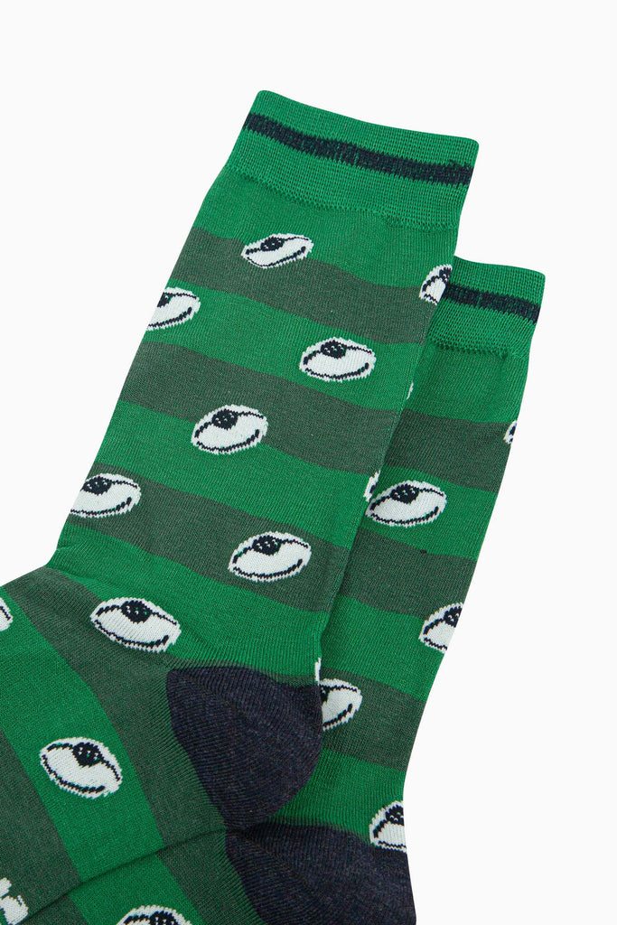 mens-bamboo-socks-green-rugby-ball-stripe-close-up-white-oval-sports-balls-green-striped-pitch