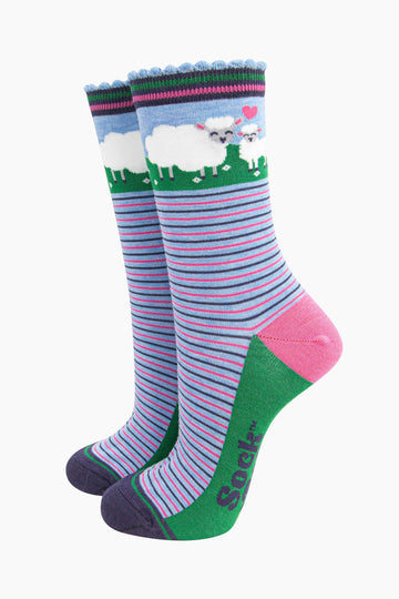 women's bamboo socks sheep and lamb. blue socks with pink and blue alternating horizontal pin stripes. the ankle features a mother sheep and baby lamb and a pink love heart.