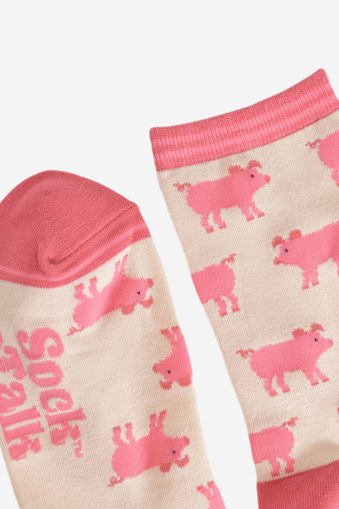 close up of the pink toe and cuff on the cream pig bamboo socks