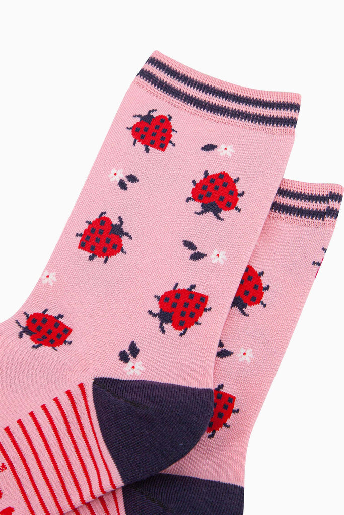 womens-bamboo-socks-pink-ladybird-close-up-red-love-heart-shaped-ladybirds-dainty-white-flowers-navy-striped-cuff