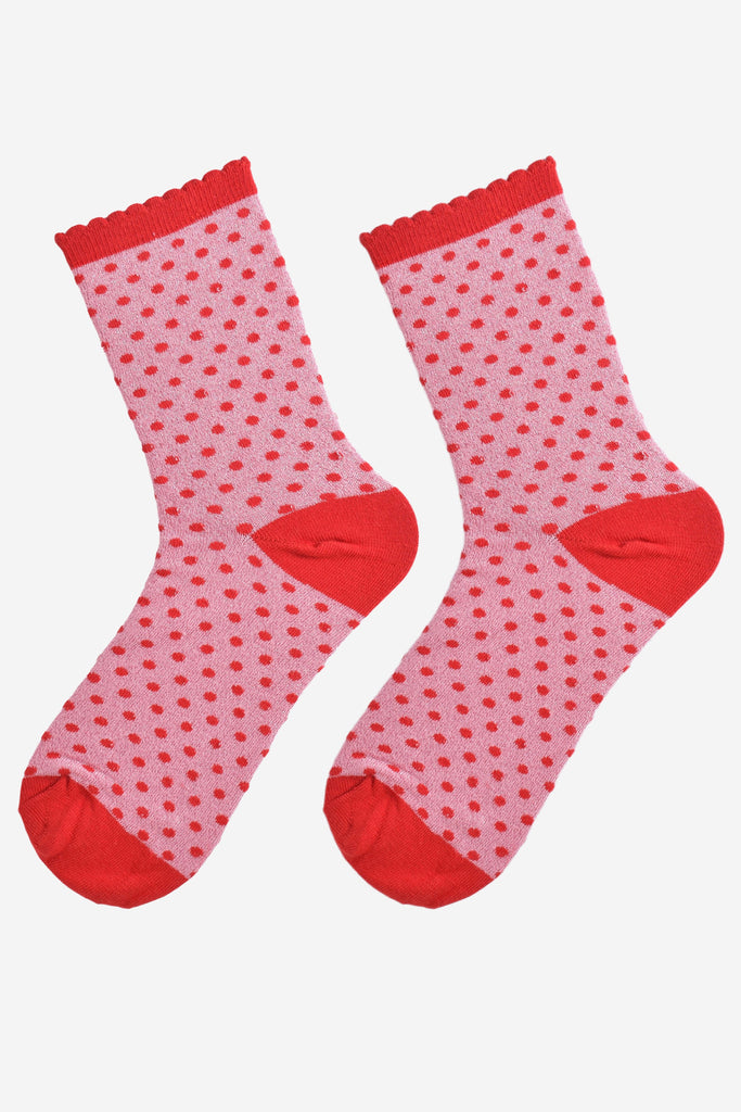 showing the pink and red polka dot socks laying flat, the small red polka dot pattern is all over the design as it the glitter sparkle