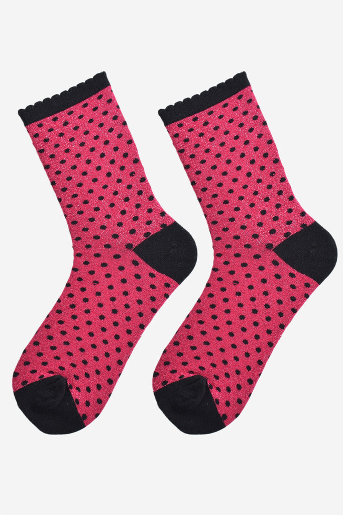 hot pink and black polka dot socks laying flat, showing the all over glitter sparkle