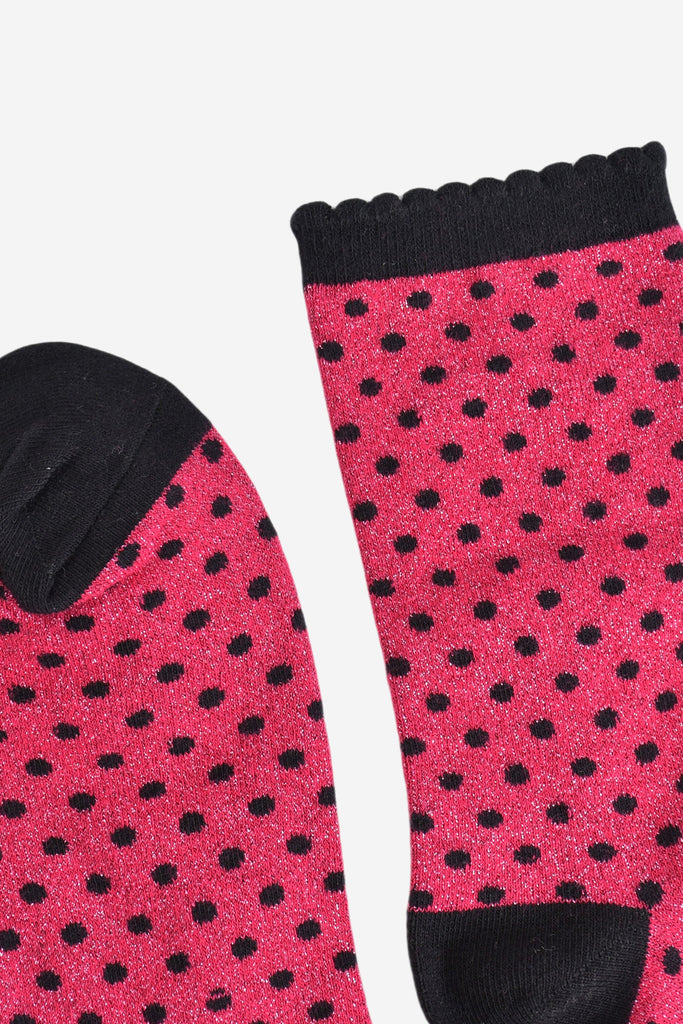 close up of the cuff and toe of the socks, they are both black and the cuff is scalloped