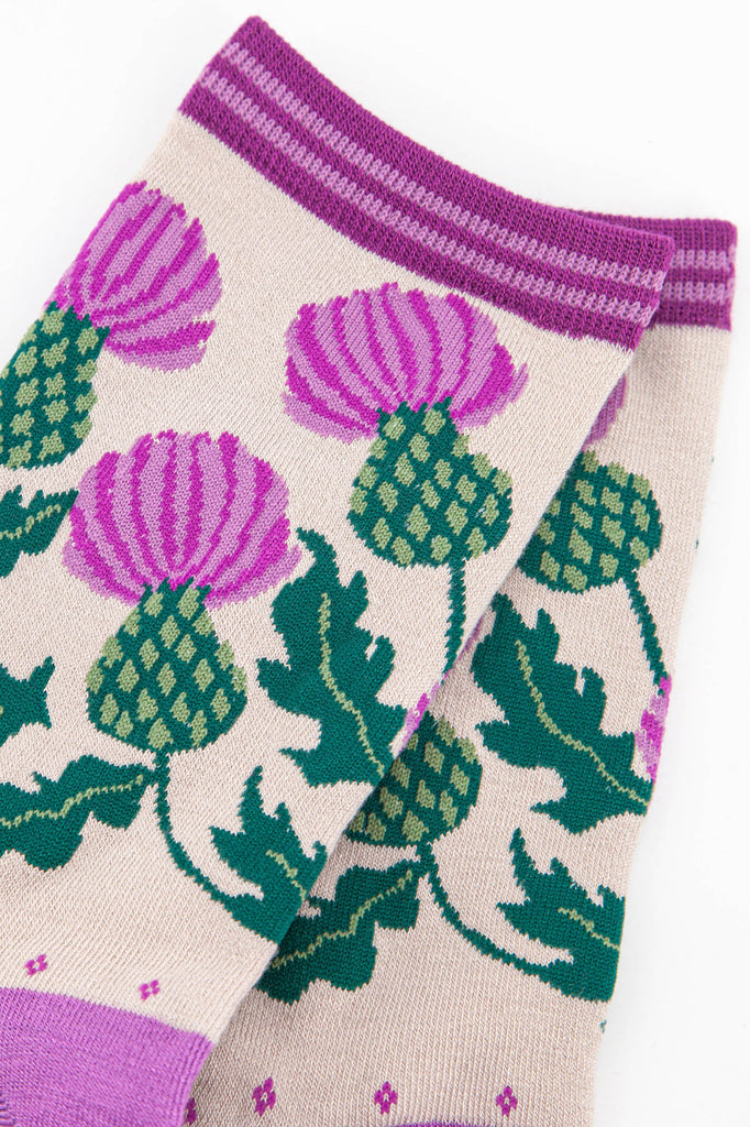 close up of the scottish thistle design, showing the purple and green colours of the flower