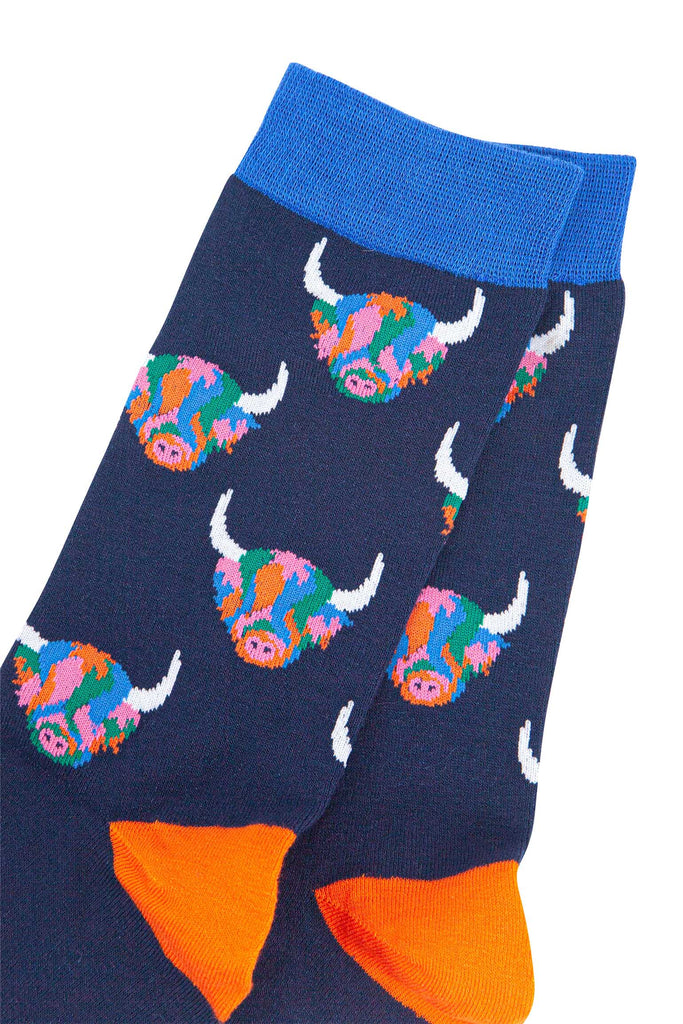 mens navy blue bamboo socks with an all over pattern of rainbow coloured highland cows