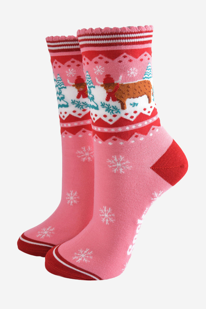 pink ankle socks with a red striped scalloped cuff with a highland cow standing in a snow covered field