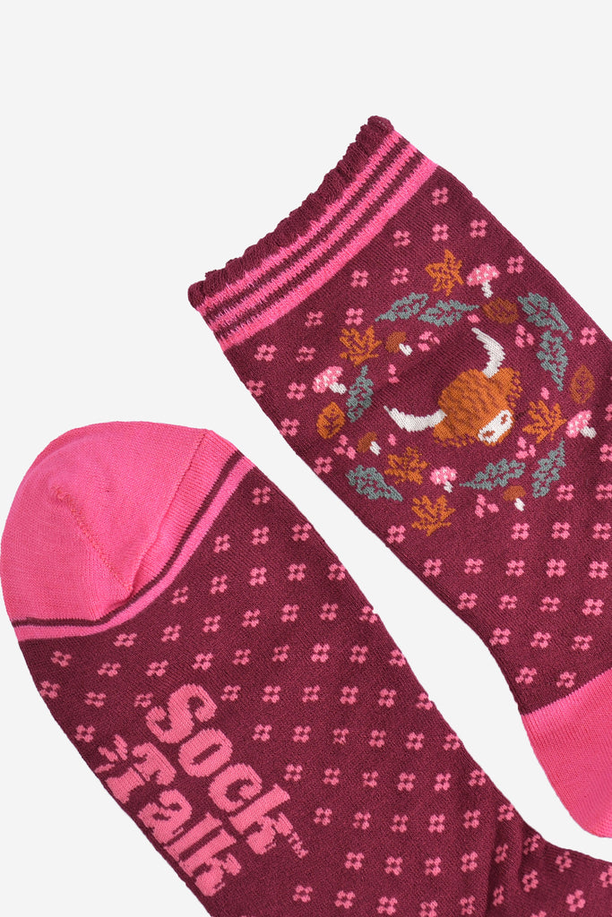 close up of the toe and cuff on the bamboo socks, the toe is pink with a burgundy stripe outline, the cuff is scalloped and has pink stripes