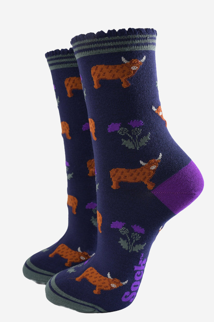 navy blue scalloped cuff ankle socks with a pattern of highland cows and thistles 