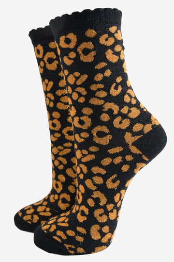 black ankle socks with an orange leopard print pattern, all over glitter sparkle and black scalloped cuff