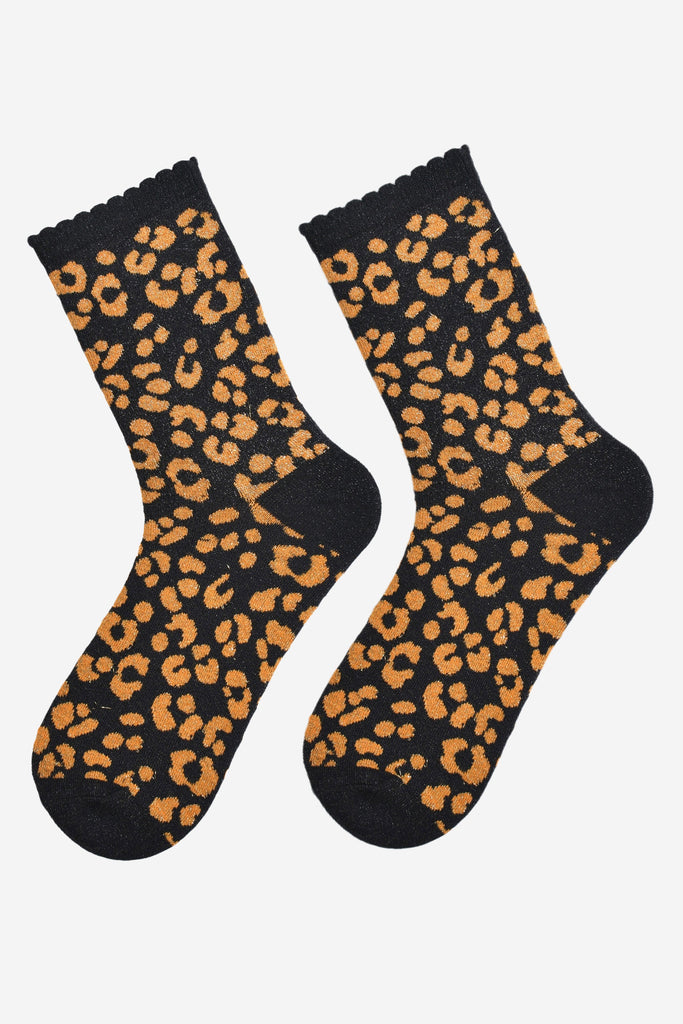 showing the orange and black leopard print ankle socks laying flat, the all over silver sparkle is visible