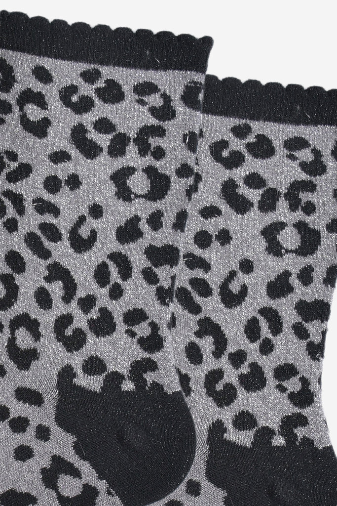 close up of the silver glitter sparkle on the grey and black leopard print glitter socks
