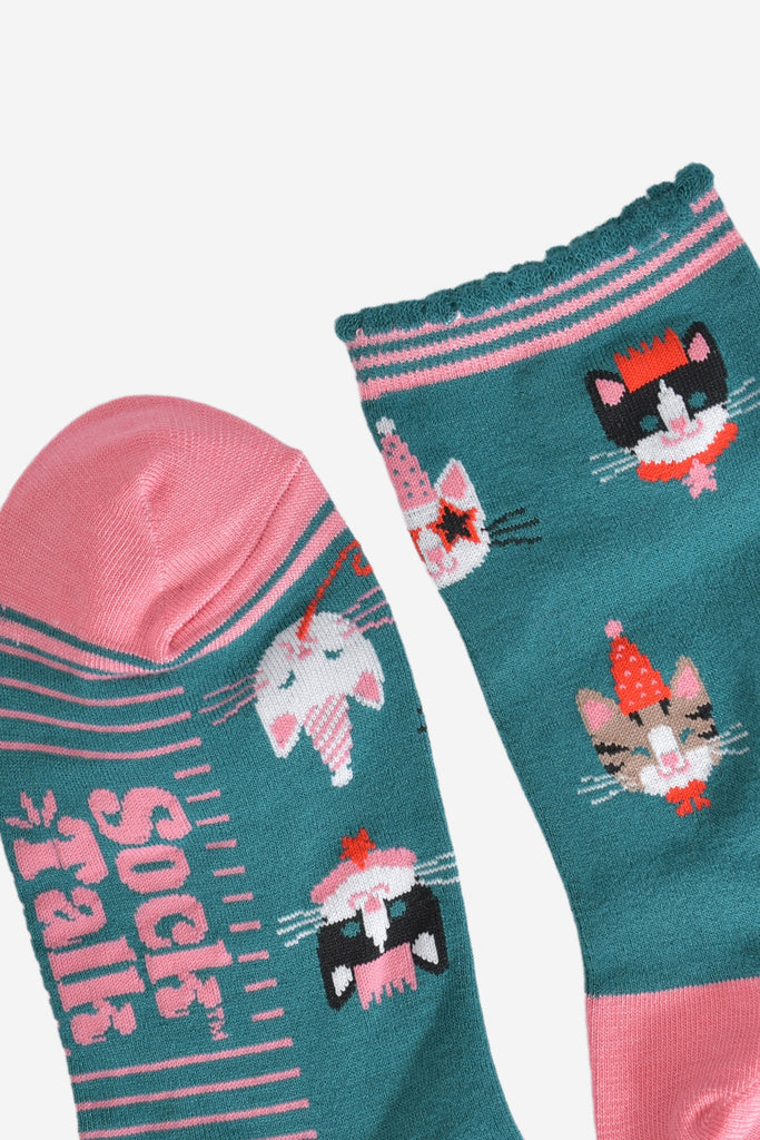 close up of the toe and cuff, the toe is pink and the cuff is scalloped with green and pink stripes