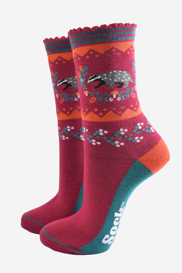 berry red socks with a woodland badger and autumnal floral wreath motif on the ankle