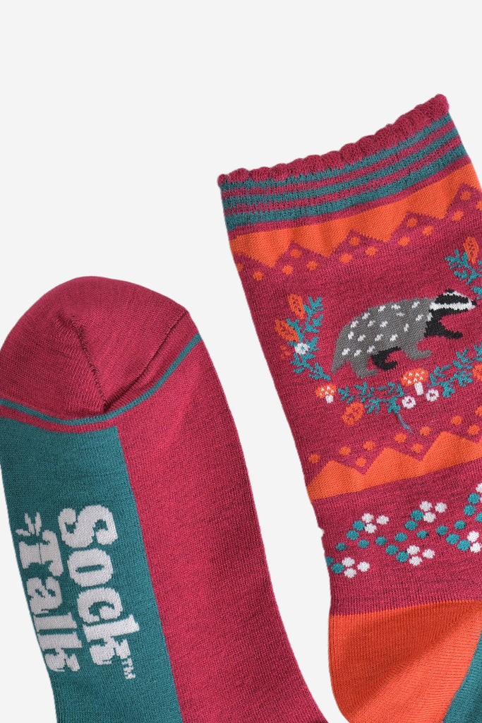 close up of the burgundy toe and burgundy and green striped scalloped cuff on the socks