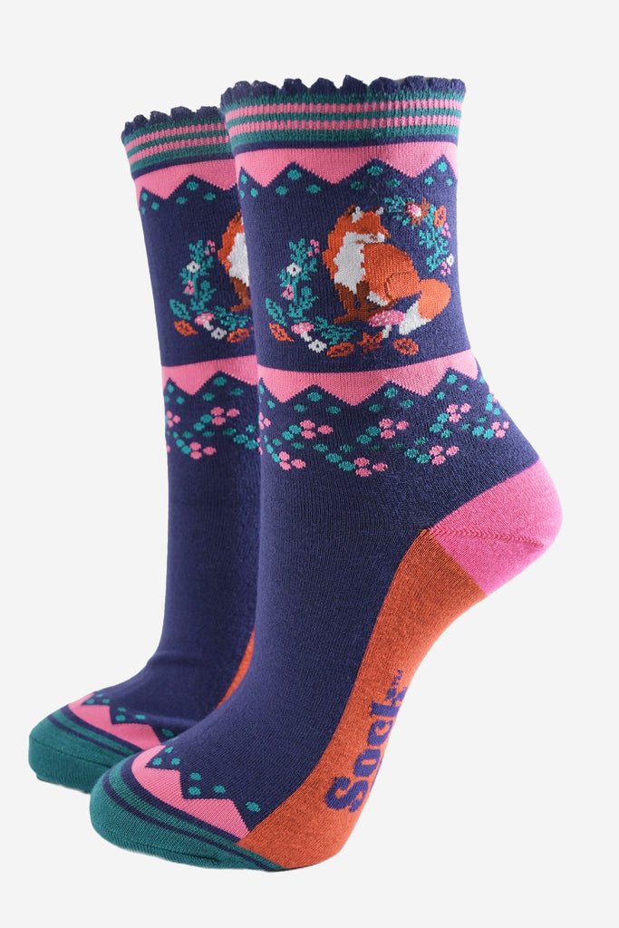 navy blue socks with pink accents and a red fox and autumnal floral wreath motif on the ankle