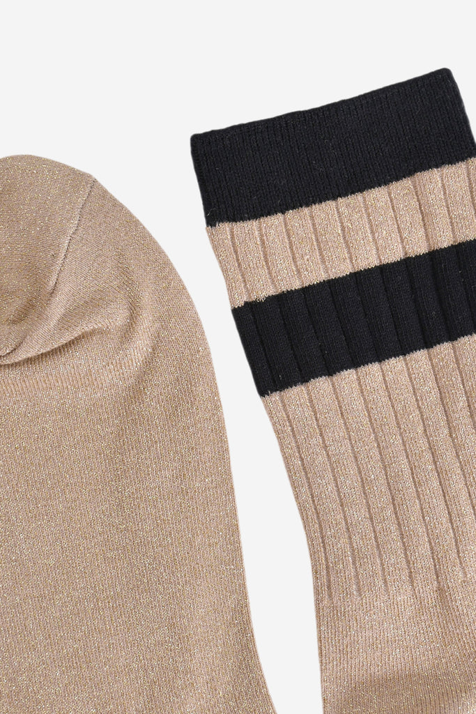 close up of the toe and cuff. the toe is gold and sparkly the same as the base of the socks. the cuff is black and without glitter.