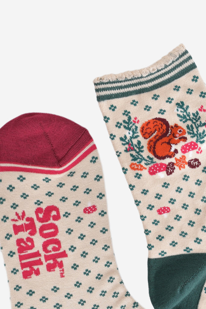 close up of the toe and cuff, the toe is burgundy in contrast to the cream colourway of the socks, the cuff is scalloped and has a green striped trim