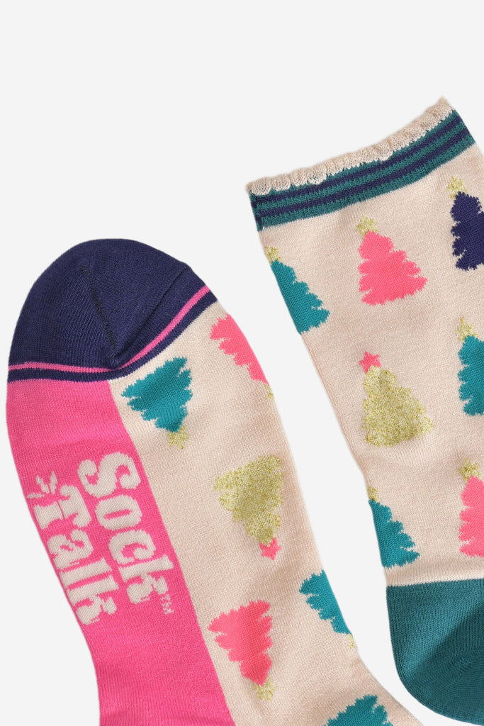 close up of the toe and cuff, the toe is navy blue with a hot pink border stripe, the cuff is scalloped and is cream with a navy and green striped trim