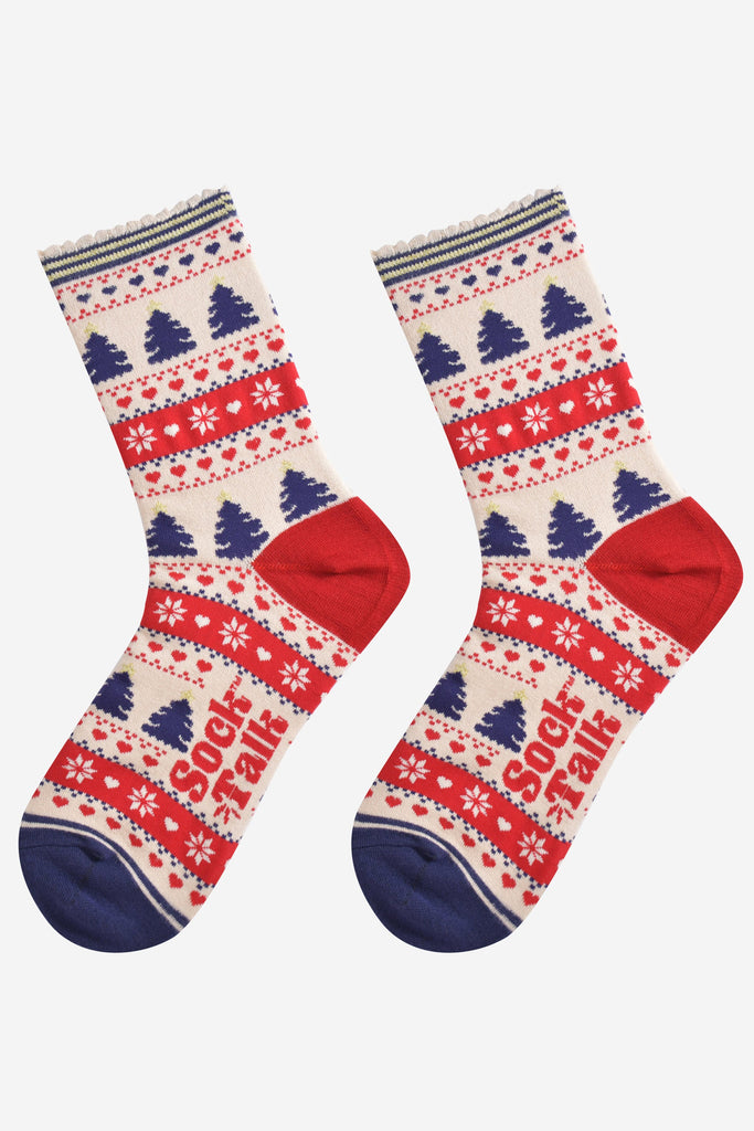 showing the fair isle christmas tree socks laying flat, showing an all over pattern featuring trees, snowflakes and hearts