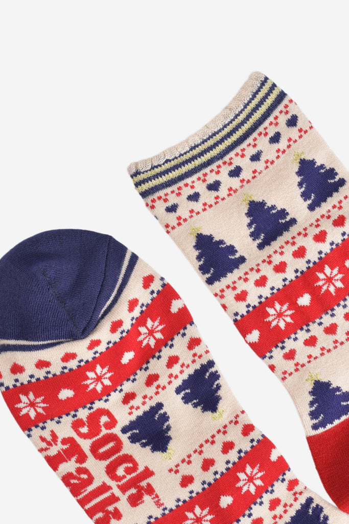 close up of the toe and cuff of the socks, the toe is navy blue and the cuff is scalloped with a cream, gold and navy stiped pattern