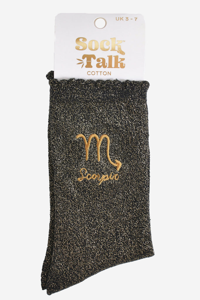 gold and black glitter scorpio socks in their sock talk packaging, these socks are a uk size 3-7