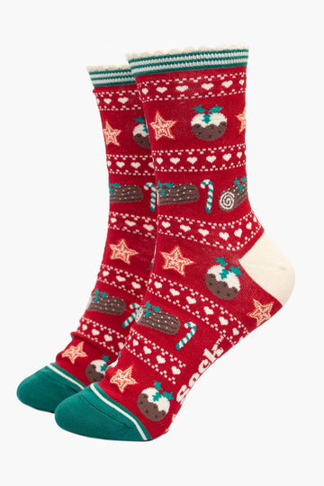 red and green fair isle style bamboo socks with a festive food themed pattern. there are xmas puddings, yule logs and candy canes all featured on the socks.